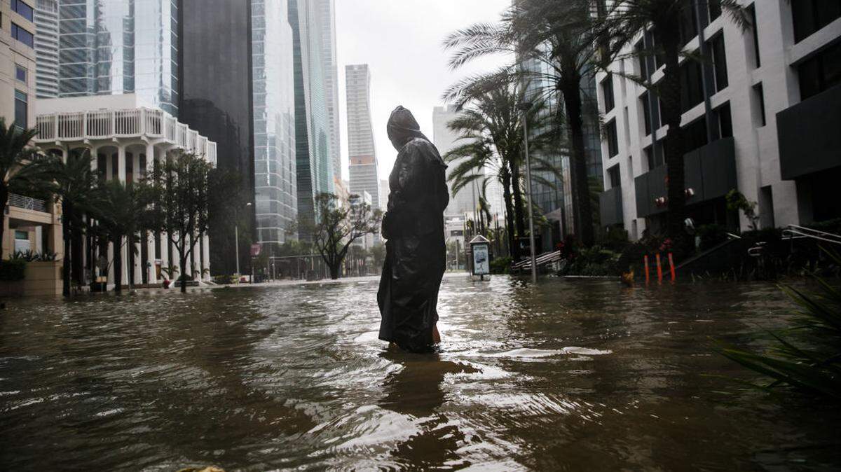 Peter Moodley wades through floodwater caused by the storm surge to assess the damage from Hurricane Irma in Miami.