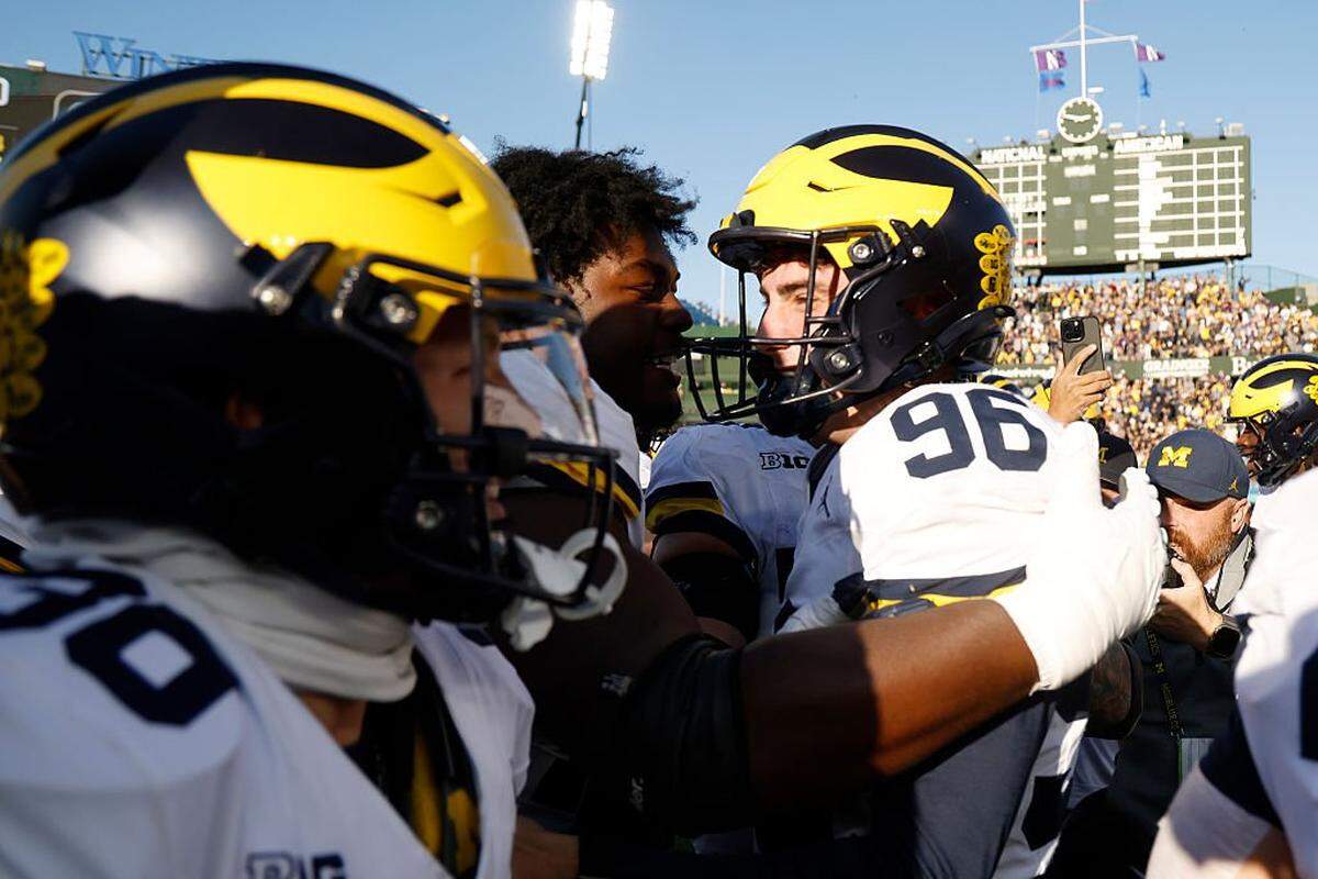 CHICAGO, ILLINOIS - NOVEMBER 15: Dominic Zvada #96 of the Michigan Wolverines celebrates with teammates after kicking a game-winning field goal as time expired to defeat the Northwestern Wildcats 24-22 at Wrigley Field on November 15, 2025 in Chicago, Illinois. (Photo by Michael Reaves/Getty Images)