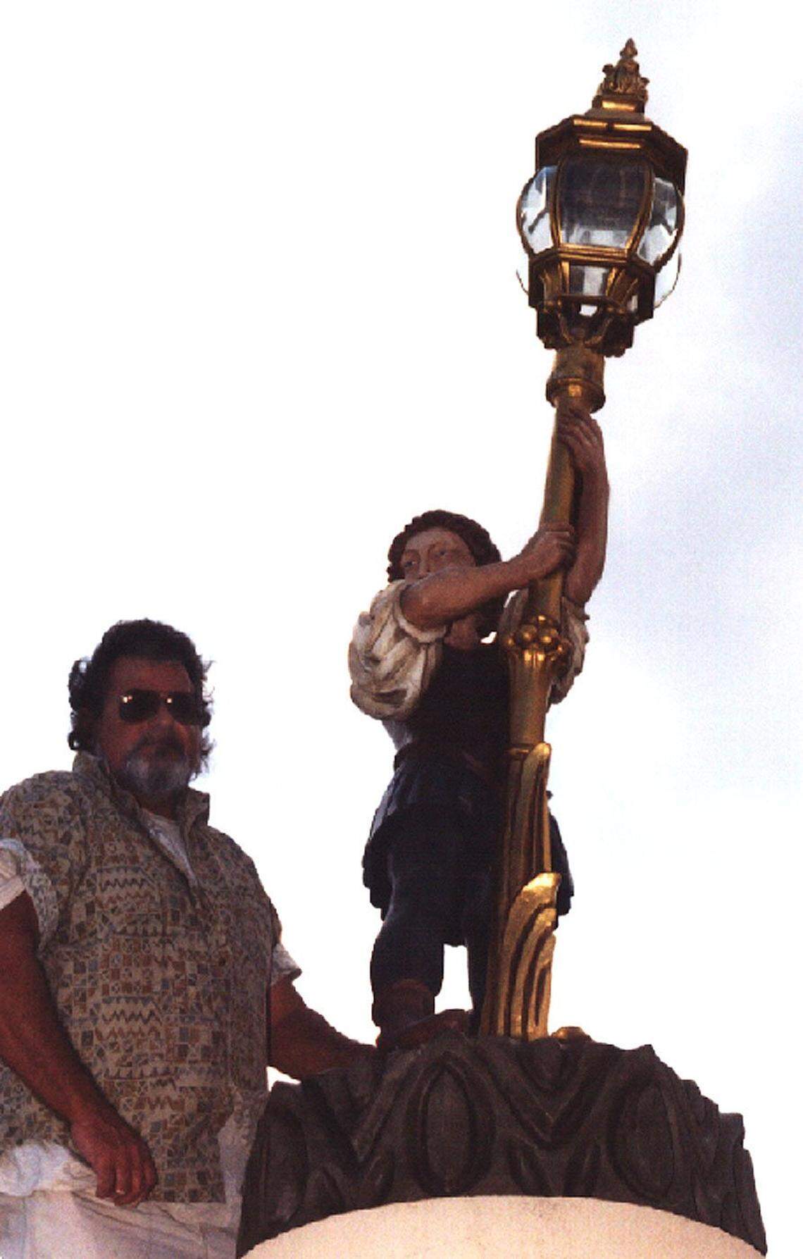 After restoration, the lantern gate boy was back in its position in 1999 at the entrance to Club Mar-a-Lago. Pictured with lantern boy is Richard Haynes who did the restoration. Pete Stachiw photo
