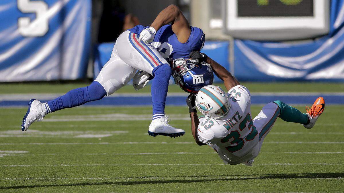 New York Giants wide receiver Sterling Shepard (87) is pulled down by Miami Dolphins cornerback Jomal Wiltz (33) during the first quarter of an NFL football game, Sunday, Dec. 15, 2019, in East Rutherford, N.J. (AP Photo/Seth Wenig)