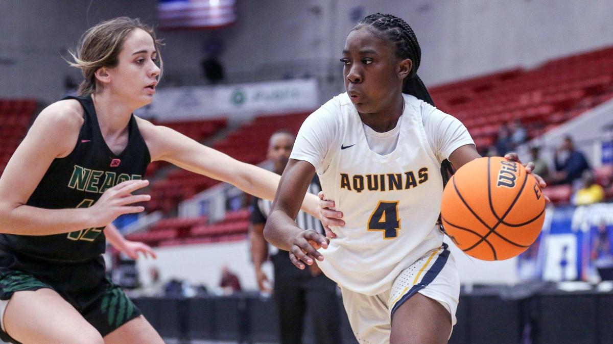 St. Thomas Aquinas point guard Karina Gordon drives the ball as Nease High School forward Allison Fifield (12) defends in a girls basketball Class 6A state semifinal at the RP Funding Center in Lakeland on Thursday, February 24, 2022.