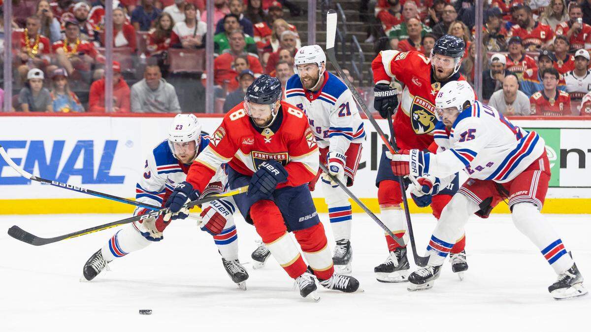 Florida Panthers right wing Kyle Okposo (8) and New York Rangers defenseman Adam Fox (23) compete for the puck in the third period of Game 4 during the Eastern Conference finals of the NHL hockey Stanley Cup playoffs at the Amerant Bank Arena on Tuesday, May 28, 2024, in Sunrise, Fla.