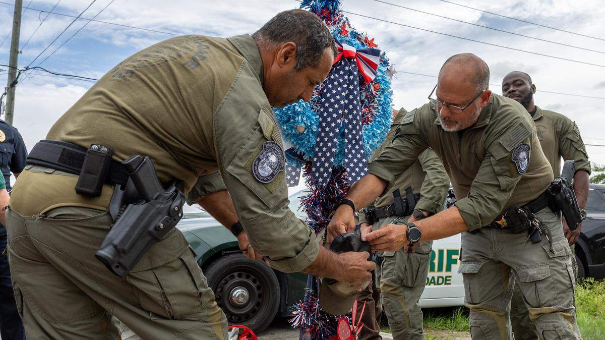 Miami-Dade Sheriff’s Office Deputy Luis Rodriguez and Sgt. Orlando Ramos fasten a cap onto the Jimmy Ryce memorial on Jimmy Ryce Avenue at the intersection of Southwest 162nd Avenue and 232nd Street in Redland on Friday, June 5, 2026.