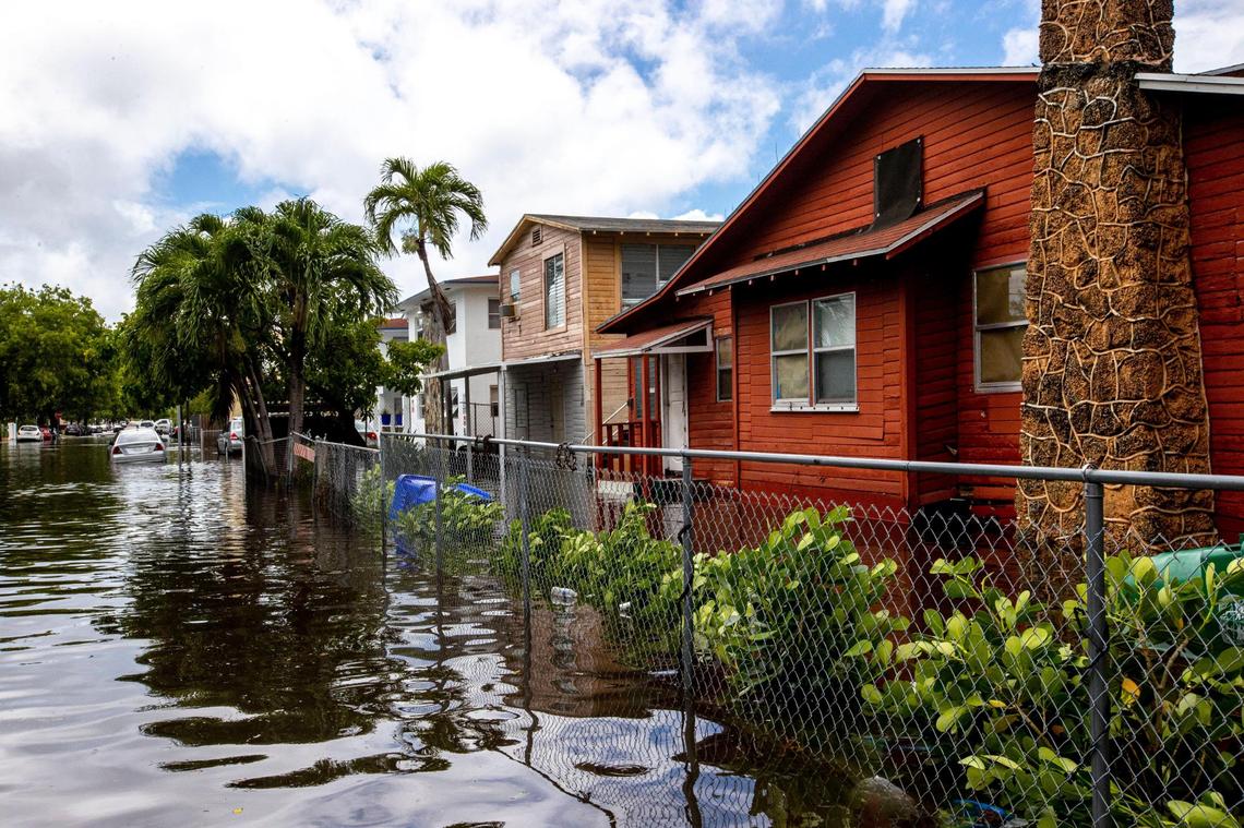 Homes surrounded by knee-high floodwaters off Southwest Fourth Street and Eighth Avenue in the Little Havana neighborhood of Miami, Florida, on Saturday, June 4, 2022. Flooding will become more common as sea level rises, and Miami-Dade may eventually have to buy out flood-prone homes.