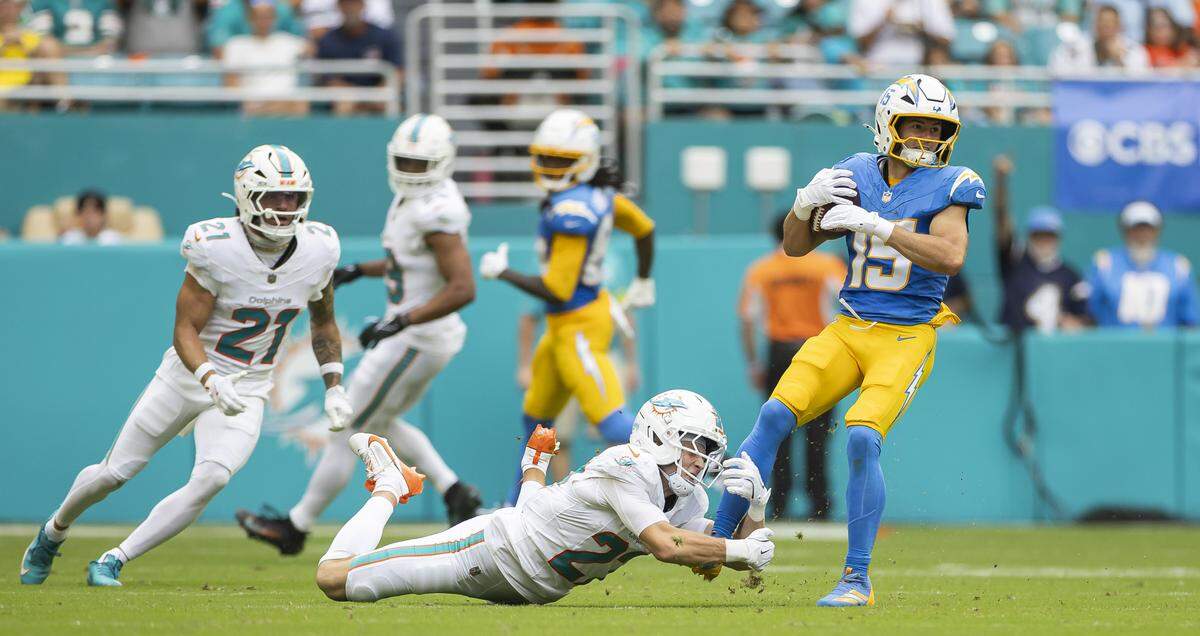 Miami Dolphins cornerback Ethan Bonner (27) fails to stop Los Angeles Chargers wide receiver Ladd McConkey (15) in the first half of their NFL game at Hard Rock Stadium on Sunday, Oct. 12, 2025, in Miami Gardens, Fla.