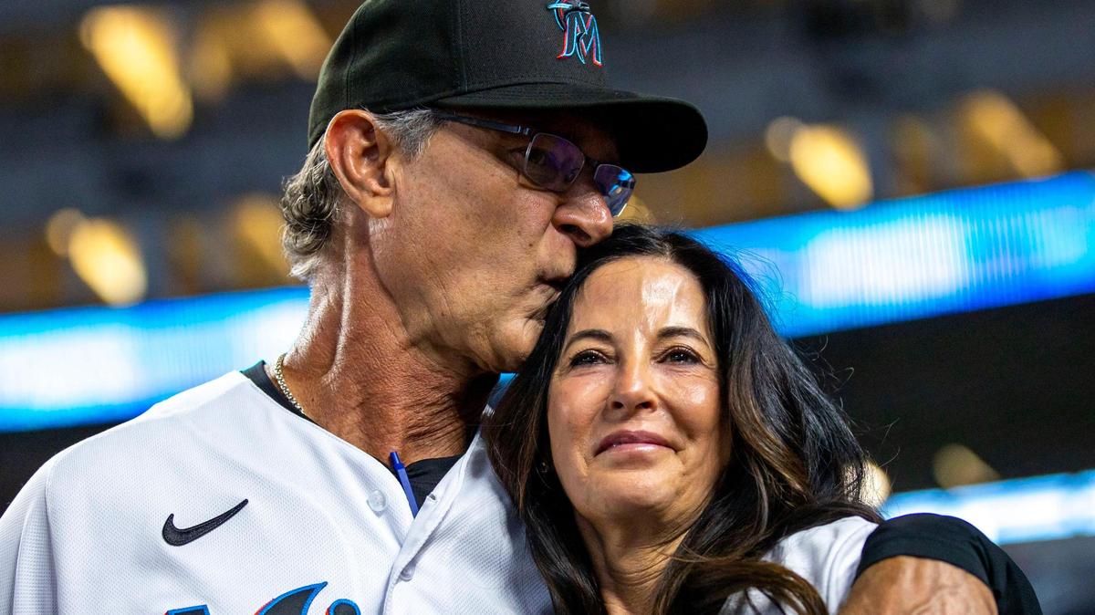 Miami Marlins manager Don Mattingly kisses his wife Lori Mattingly during his final MLB game at loanDepot park in the Little Havana neighborhood of Miami, Florida, on Wednesday, October 5, 2022.