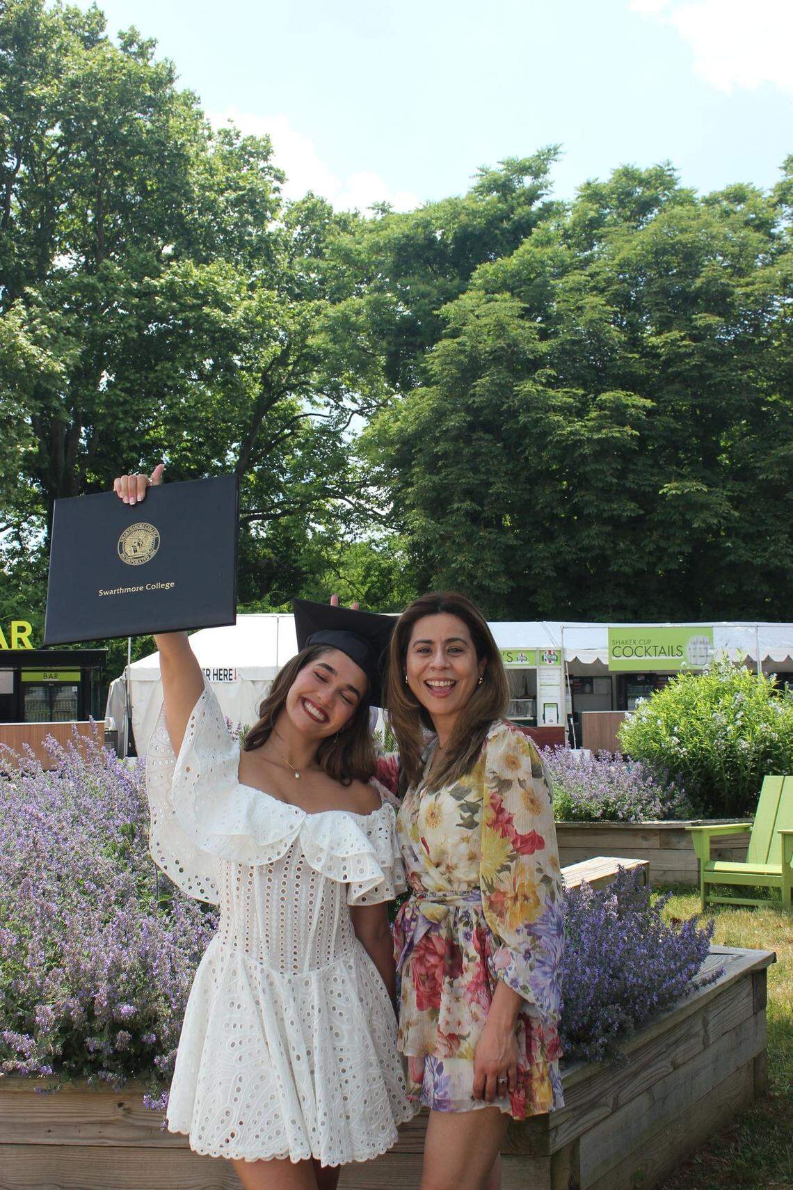 Alexia Couyutas Duarte (left) holds her graduation certificate aloft from Swarthmore College and her maternal aunt Ana Kinlen Duarte on graduation day in May 2024.