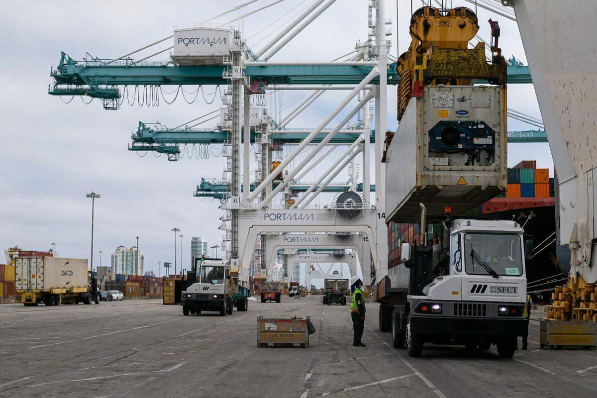 Longshoremen work to offload containers from a cargo ship at PortMiami on Saturday, February 20, 2021.