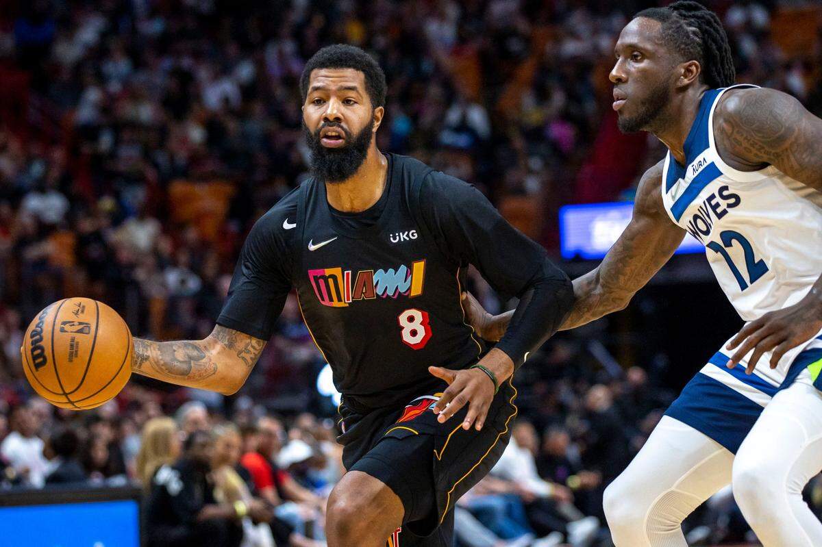 Miami Heat forward Markieff Morris (8) passes the ball while defended by Minnesota Timberwolves forward Taurean Prince (12) during the first quarter of an NBA game at FTX Arena in Miami on Saturday, March 12, 2022.