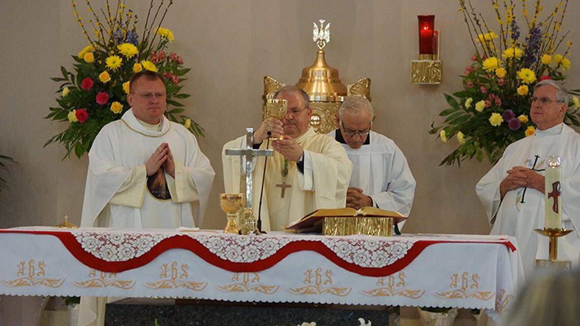 Miami Auxiliary Bishop Peter Baldacchino celebrates Mass at St. Coleman Parish on Divine Mercy Sunday with Father Henryk Pawelec, left.