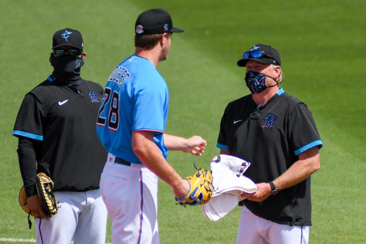 Miami Marlins pitcher Trevor Rogers talks with pitching coach Mel Stottlemyre Jr. prior to a spring training game against the Houston Astros on Friday, March 5, 2021, at Roger Dean Chevrolet Stadium in Jupiter, Florida.