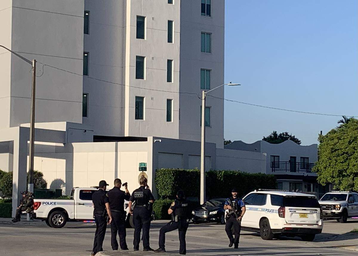 Miami police near the Columbus on Fifth apartment building, Southwest 22nd Avenue and Fifth Street, as they search the area for carjacking suspects Sunday, July 27, 2025.