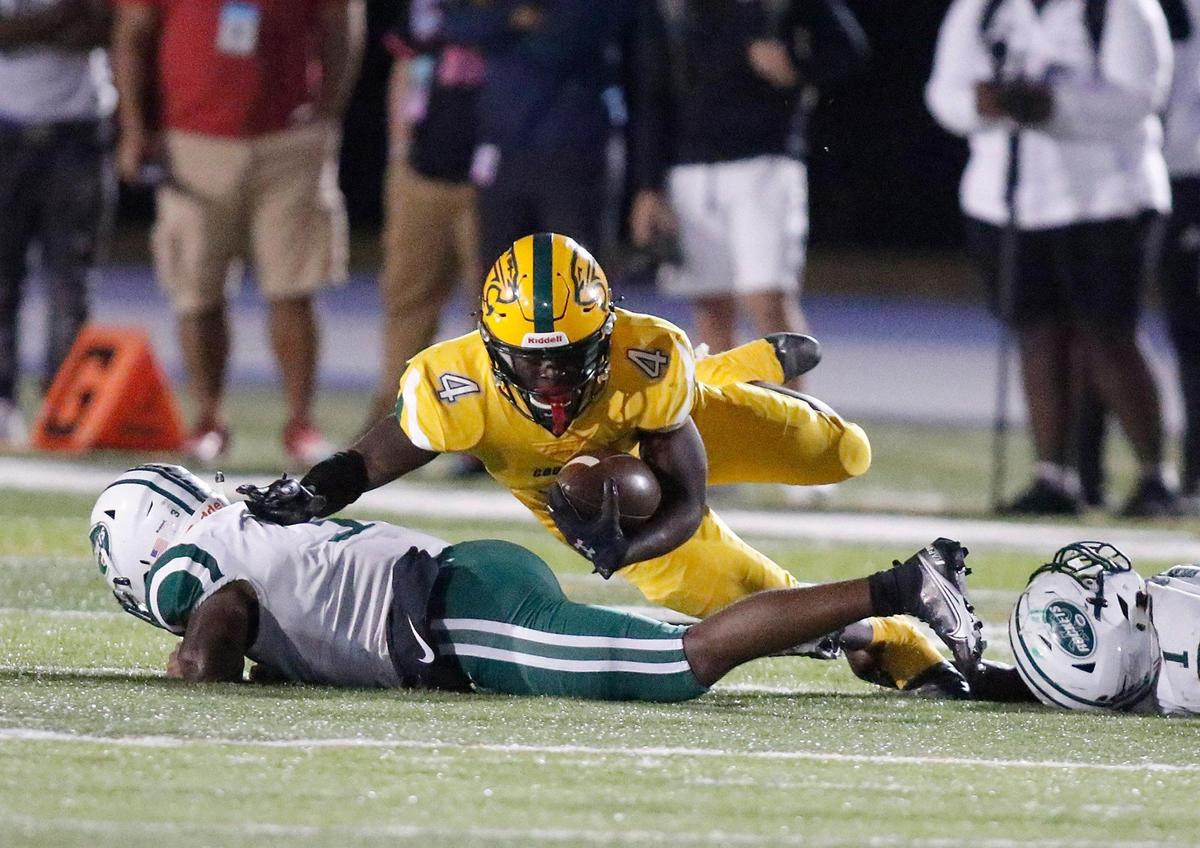 Killian Cougars running back Maurice Jones (4) is taken down by Miami Central Rockets during the FHSAA Region 4-5A high school football championship on Saturday, November 27, 2021 at Tropical Park in Miami. Andrew Uloza / for THE MIAMI HERALD