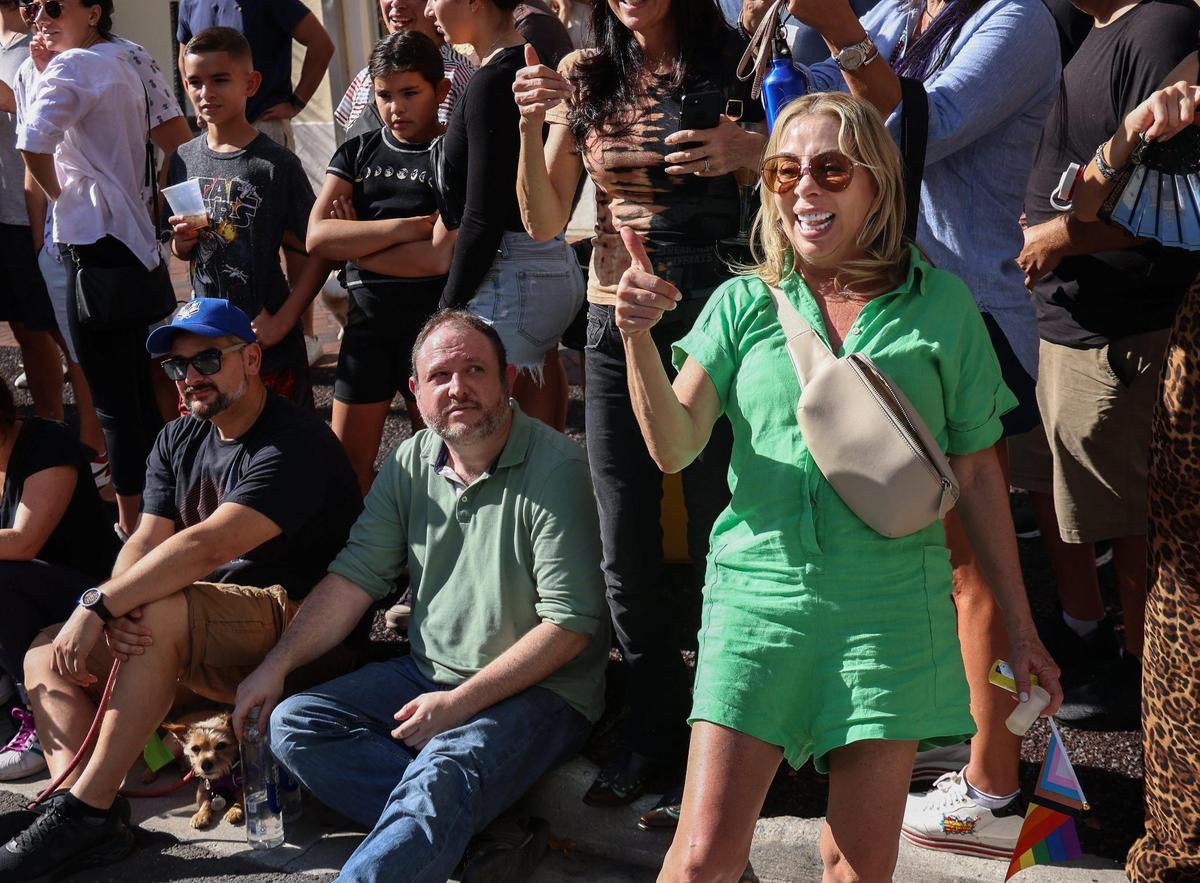 A parade watcher at the 39th Annual King Mango Strut in Coconut Grove gets the “King Coin” reference as paraders mock the FTX debacle.