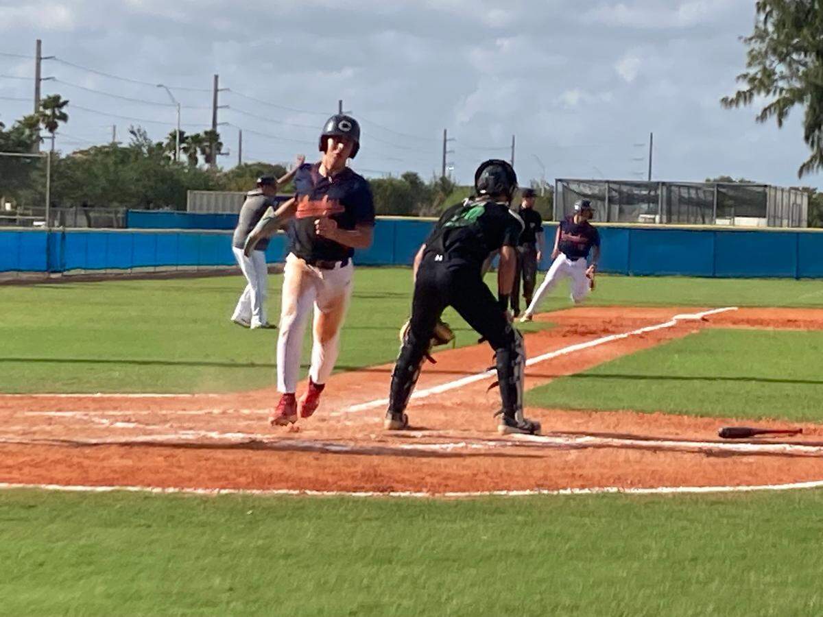 Columbus’ Aquiles Arzano crosses the plate to score his team’s first run in the second inning of Friday’s GMAC championship win over Varela at Miami-Dade College North Campus field.