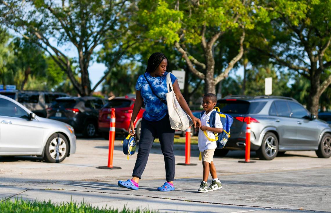 Amari Alcira, 5, and his mother, Marie Sydney, arrive for the first day of school at Winston Park Elementary School in Coconut Creek on Tuesday, Aug. 16, 2022.