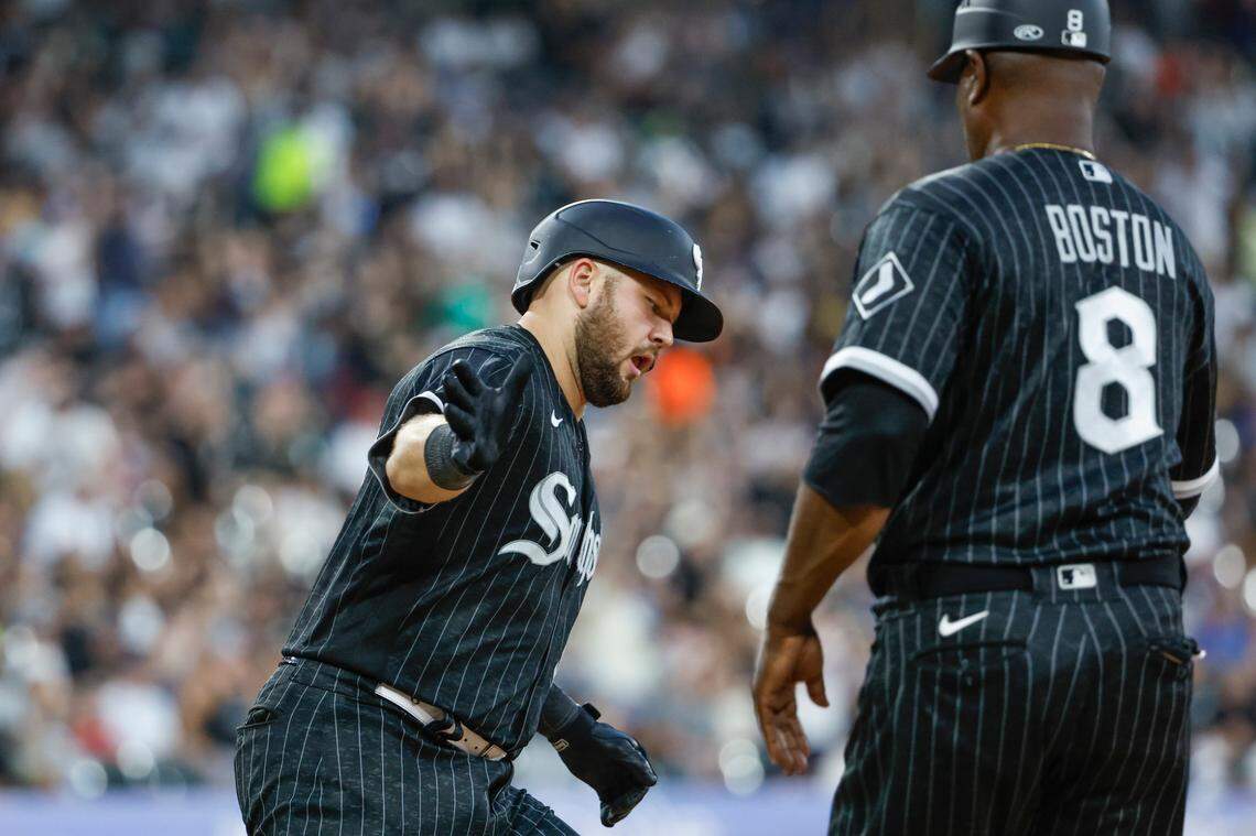 Jul 28, 2023; Chicago, Illinois, USA; Chicago White Sox third baseman Jake Burger (30) celebrates with first base coach Daryl Boston (8) after hitting a solo home run against the Cleveland Guardians during the sixth inning at Guaranteed Rate Field.