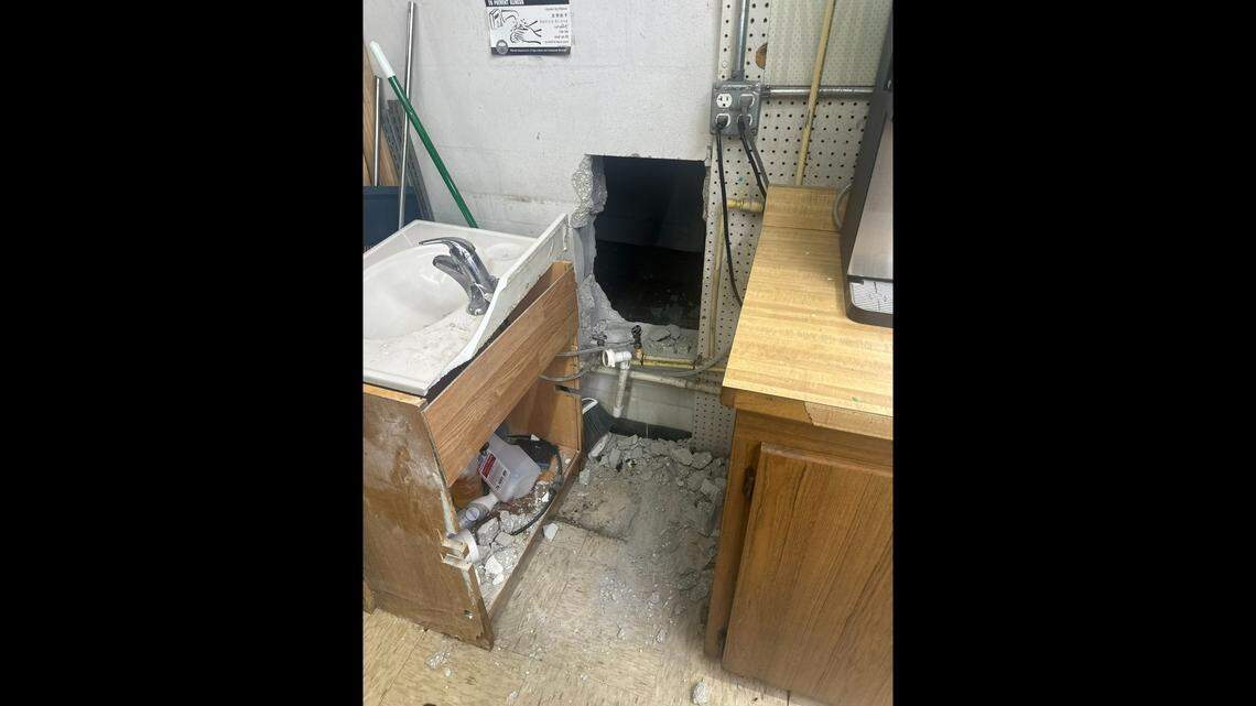 The trio used a sledge hammer to break through the wall of the grocery store, and ended up facing the back of a sink, officials say.