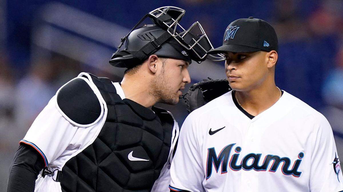 Miami Marlins catcher Alex Jackson, left, talks with Miami Marlins starting pitcher Jesus Luzardo, right, during the second inning of a baseball game against the New York Mets, Monday, Aug. 2, 2021, in Miami. (AP Photo/Lynne Sladky)