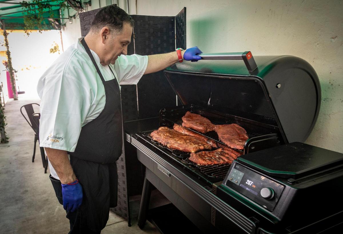 Chef Mario Barone checks the prime rib inside the smoker at La Veridica BBQ in Hialeah.