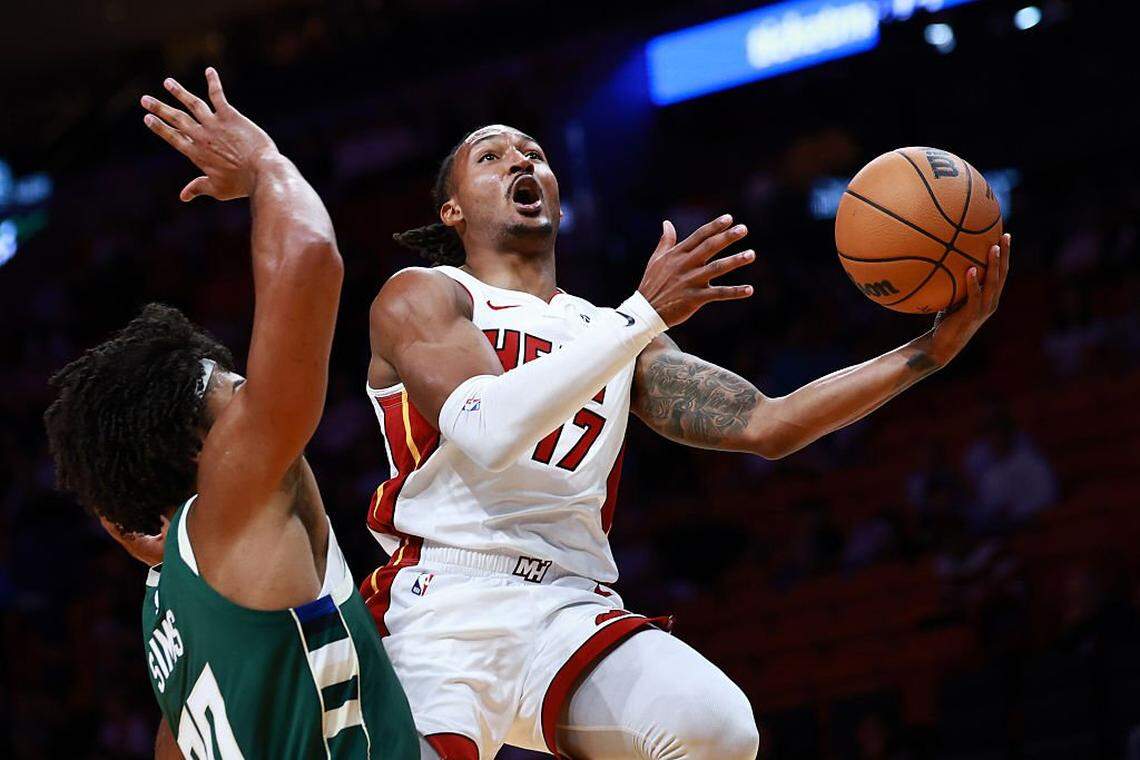 MIAMI, FLORIDA - OCTOBER 06: Jahmir Young of the Miami Heat drives to the net against Jericho Sims #00 of the Milwaukee Bucks during the second half at Kaseya Center on October 06, 2025 in Miami, Florida. NOTE TO USER: User expressly acknowledges and agrees that, by downloading and/or using this Photograph, user is consenting to the terms and conditions of the Getty Images License Agreement (Photo by Carmen Mandato/Getty Images)