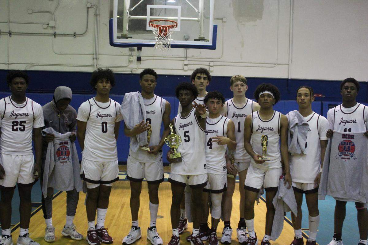 Pembroke Pines Charter players celebrate after beating Dillard 74-59 to secure the BCAA Big 8 boys basketball championship on Saturday night at Fort Lauderdale High.