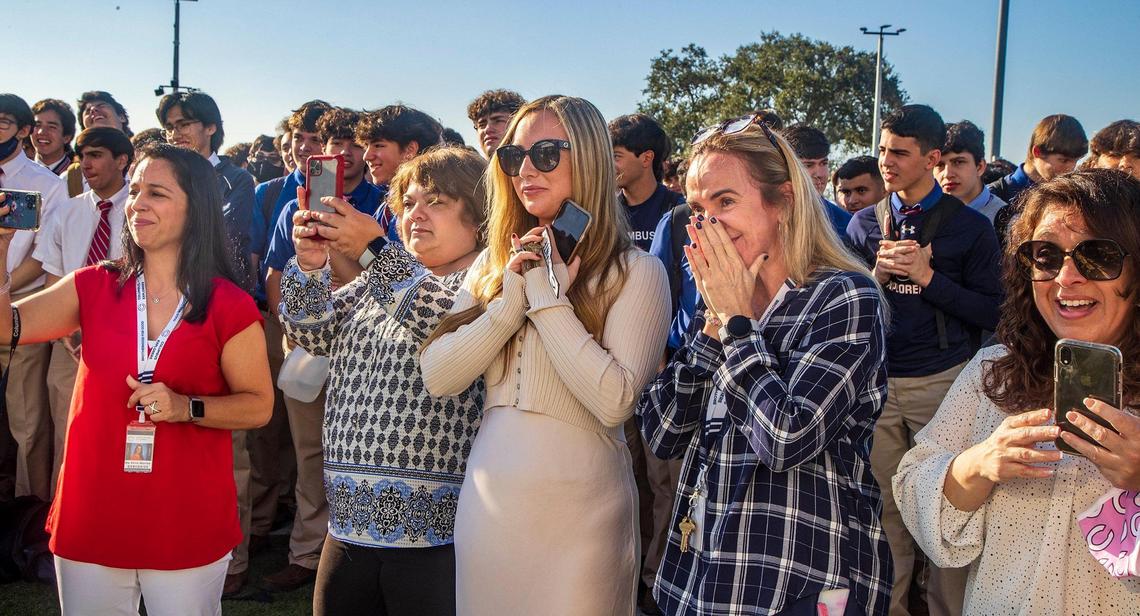 Columbus High School Staff members react after entrepreneur and TV personality Marcus Lemonis surprised everyone announcing his donation of $10 million to build two centers and to cover $18,000 checks for all staff and employees at his Miami alma mater, on Thursday, Dec. 9, 2021.