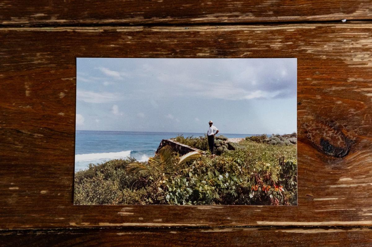 A photo of David Lawrence Adderley standing on his land in The Bahamas.