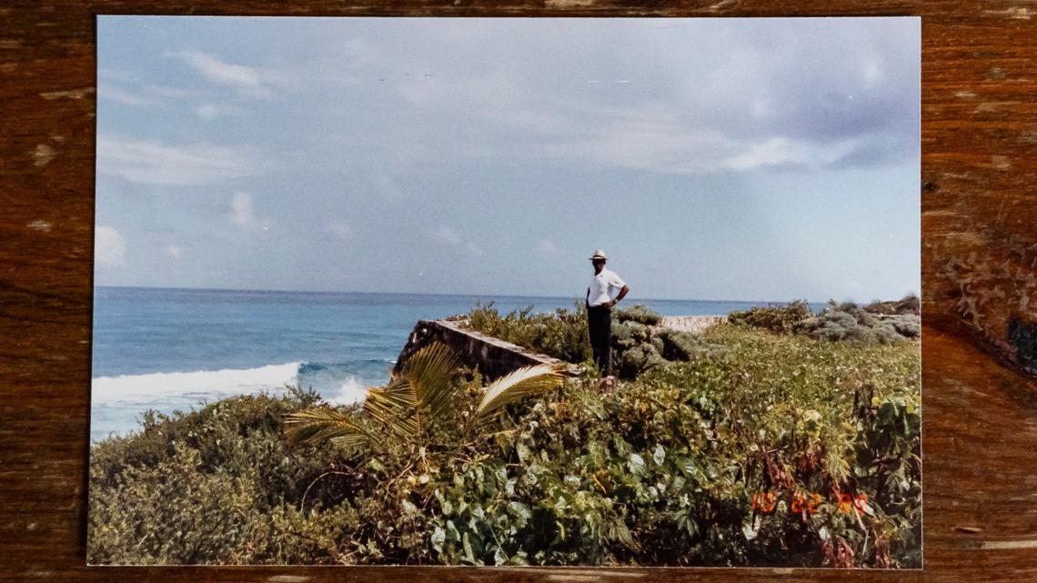 A photo of David Lawrence Adderley standing on his land in The Bahamas.