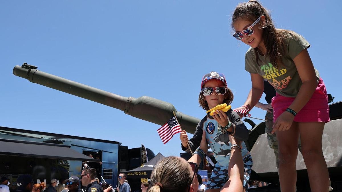 Liam Arias, 4, stares as his new tank toy as his mother, Kate Arias, left, and sister, Mila Arias, 10, right, assist him off the U.S. Army’s M-1 tank. On Sunday, May 28, 2023 the Hyundai Air & Sea Show returned to Miami Beach on Memorial Day Weekend (May 27, 2023 and May 28, 2023.) The event showcases the men, women, technology, and equipment from all five branches of the United States military as well as local police, firefighters, and their first responder agencies. The four block long Display Village that contains a Kid Zone, flight and navigation simulators, tactical training equipment, rifle range simulators, interactive displays from all five branches of the U.S. Military and the Monster Energy Action Zone which showcases a one-of-a-kind action-packed motocross performance by Keith Sayer’s FMX (Freestyle Motocross) demonstration team.
