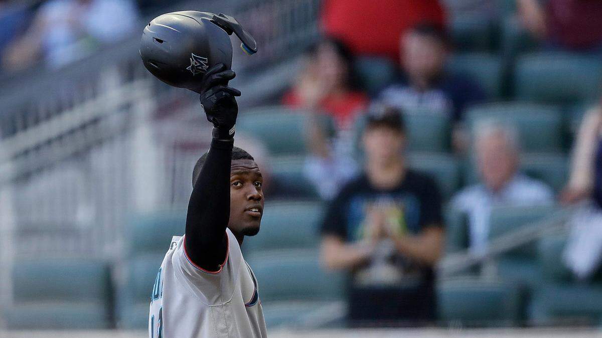 Miami Marlins’ Jorge Soler tips his helmet to fans as he prepares to bat against the Atlanta Braves during the first inning of a baseball game Friday, April 22, 2022, in Atlanta. Soler was the World Series MVP while playing for the Braves in 2021. (AP Photo/Ben Margot)