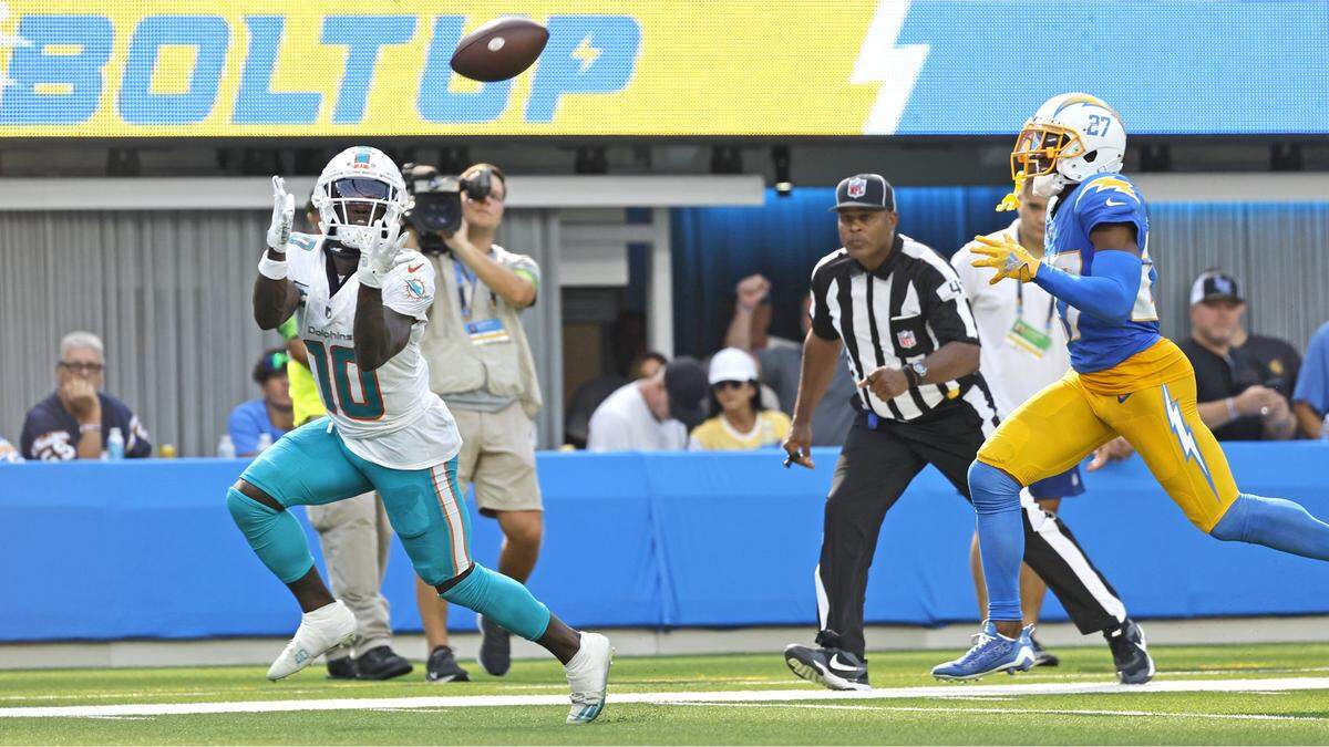 Miami Dolphins wide receiver Tyreek Hill (10) catches a long bomb as Los Angeles Chargers cornerback J.C. Jackson (27) fails to defend in the second half at SoFi Stadium in Inglewood, California on Sunday, September 10, 2023.