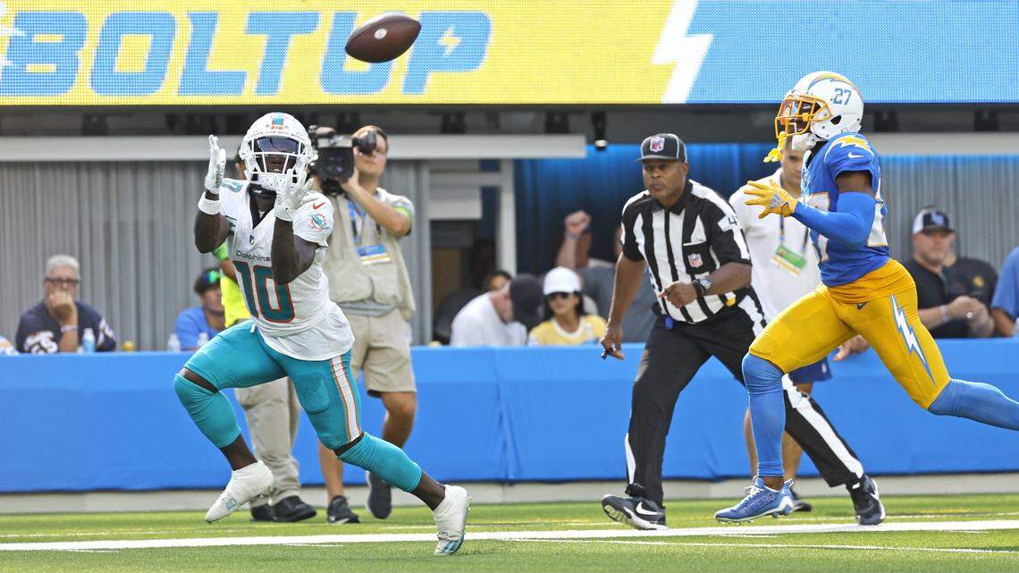 Miami Dolphins wide receiver Tyreek Hill (10) catches a long bomb as Los Angeles Chargers cornerback J.C. Jackson (27) fails to defend in the second half at SoFi Stadium in Inglewood, California on Sunday, September 10, 2023. 