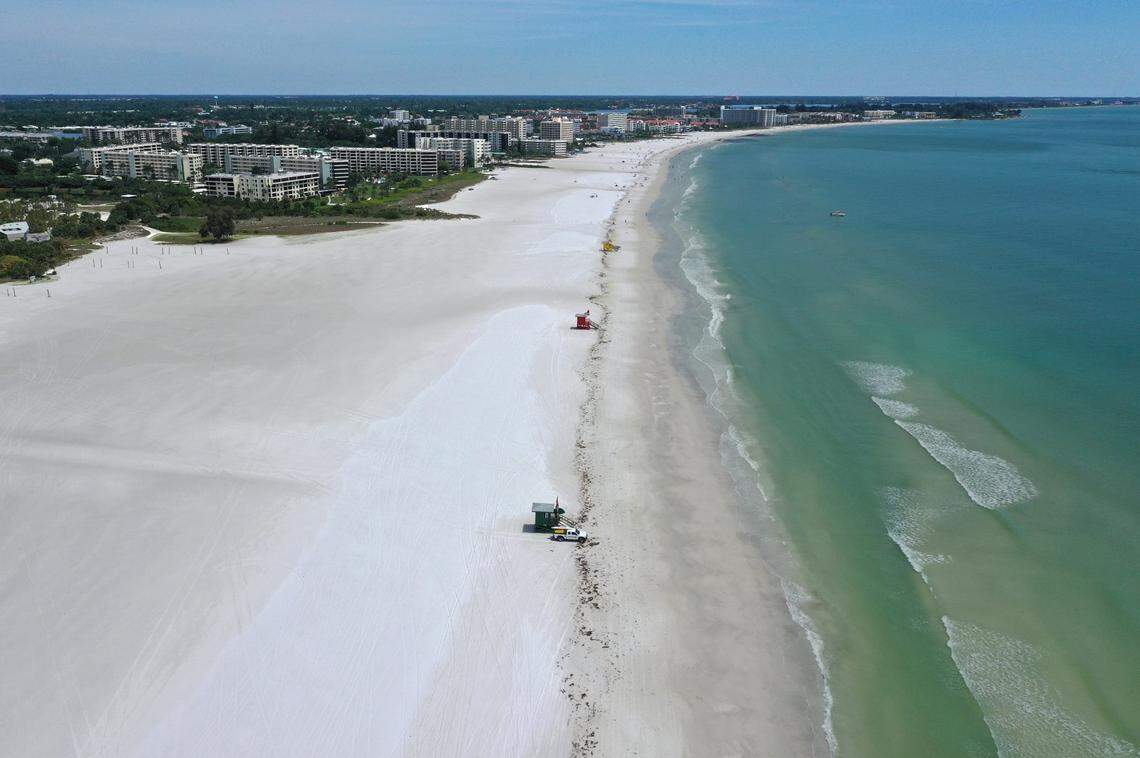 An aerial view of the empty Siesta Key Beach, photographed April 22, 2020, when it was closed due to the COVID-19 pandemic. Sarasota County commissioners soon re-opened part of the county’s 35 miles of pristine shoreline for biking, running, walking, swimming and surfing.
