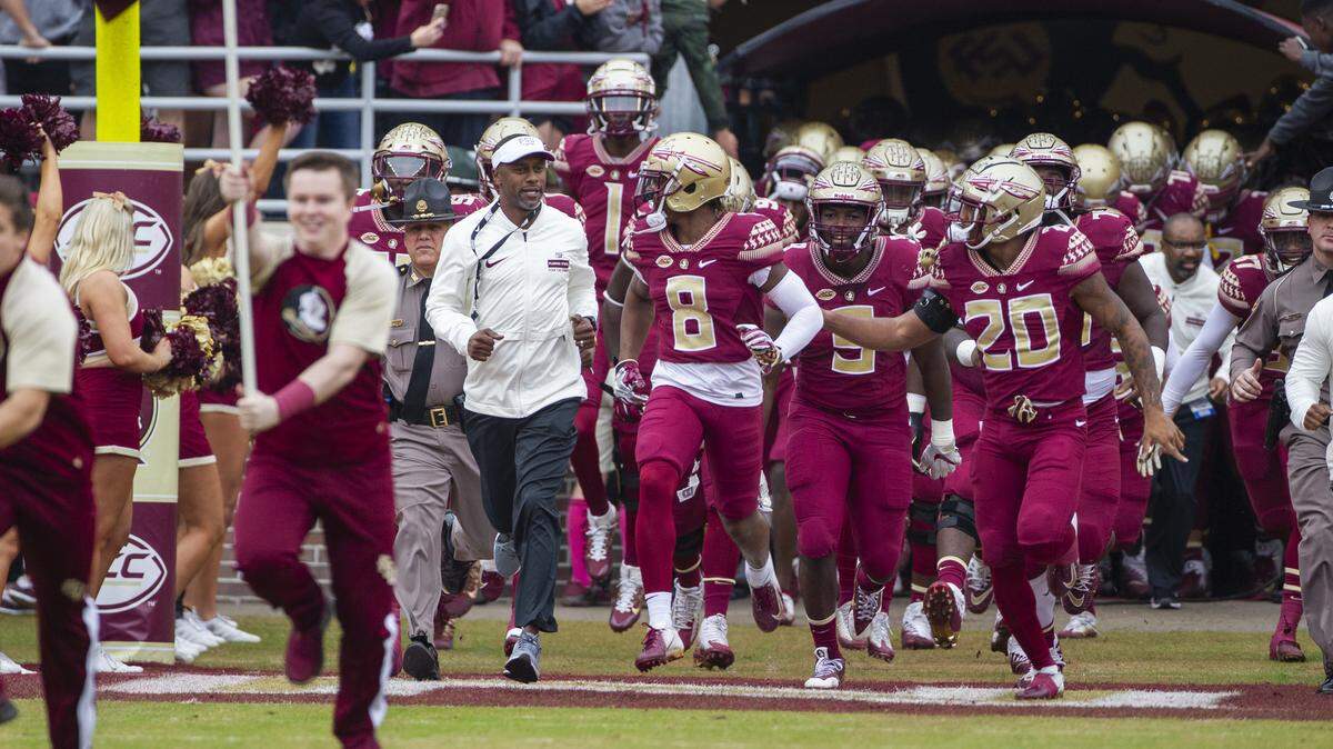 Florida State Seminoles head coach Willie Taggart, center, leads his team onto the field before an NCAA college football game against Florida in Tallahassee, Fla., Saturday, Nov. 24, 2018.