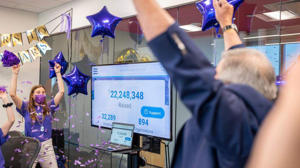 Nicky Zarchen, communications and public affairs officer with The Miami Foundation, celebrates a $10 million anonymous donation along with Foundation Board Chair Richard Berkowitz Thursday night, Nov. 18, 2021. The Miami Foundation raised $33.4 million during the 10th annual, 24-hour Give Miami Day event.