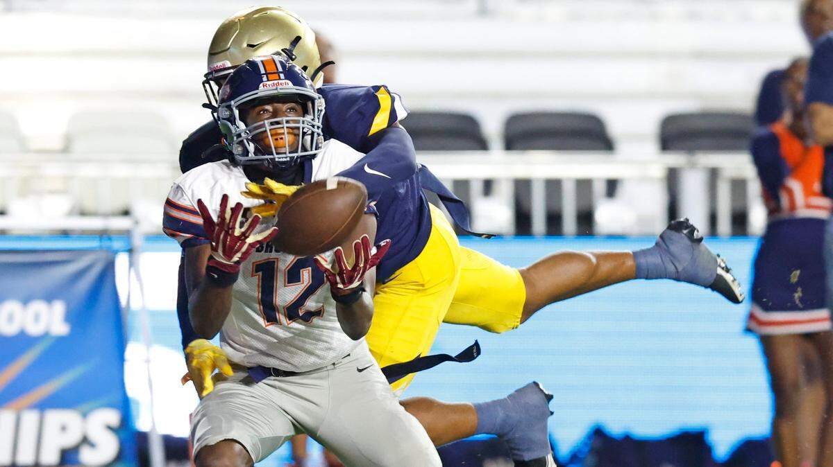 Homestead wide receiver Cortez Mills (12) attempts to catch a pass in the end zone as St. Thomas Aquinas Kimari Robinson (5) defends during the 2022 FHSAA State Championships-Class 3M at DRV PNK Stadium in Ft. Lauderdale on Thursday, December 15, 2022. Pass interference was called on Robinson in the second quarter.