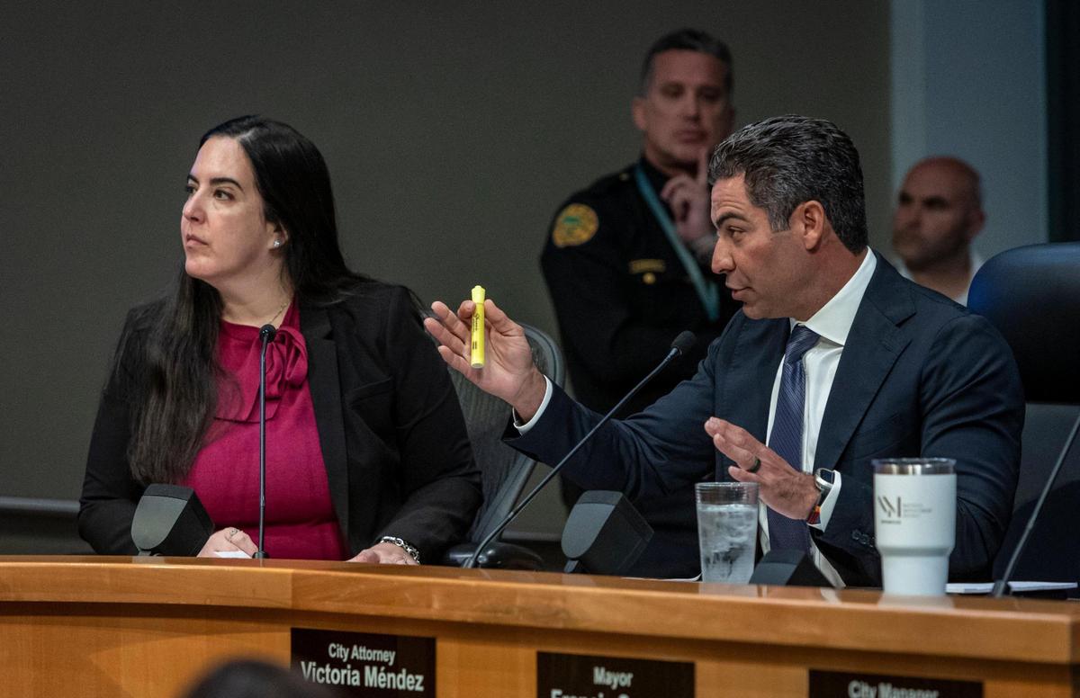 Miami, Florida, January 11, 2024 - Miami Mayor Francis Suarez, right, speaks during today’s commission meeting as City Attorney Victoria Mendez, left, listens.