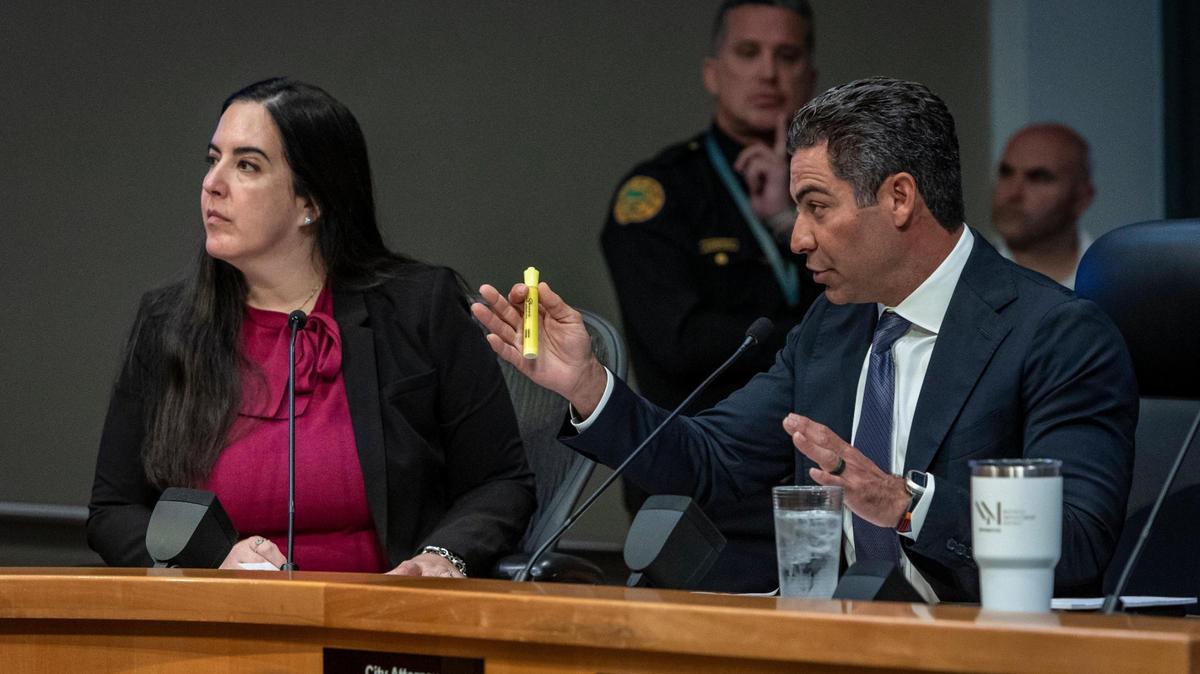 Miami Mayor Francis Suarez, right, speaks during a commission meeting on Jan. 11, 2024, as City Attorney Victoria Mendez, left, listens.
