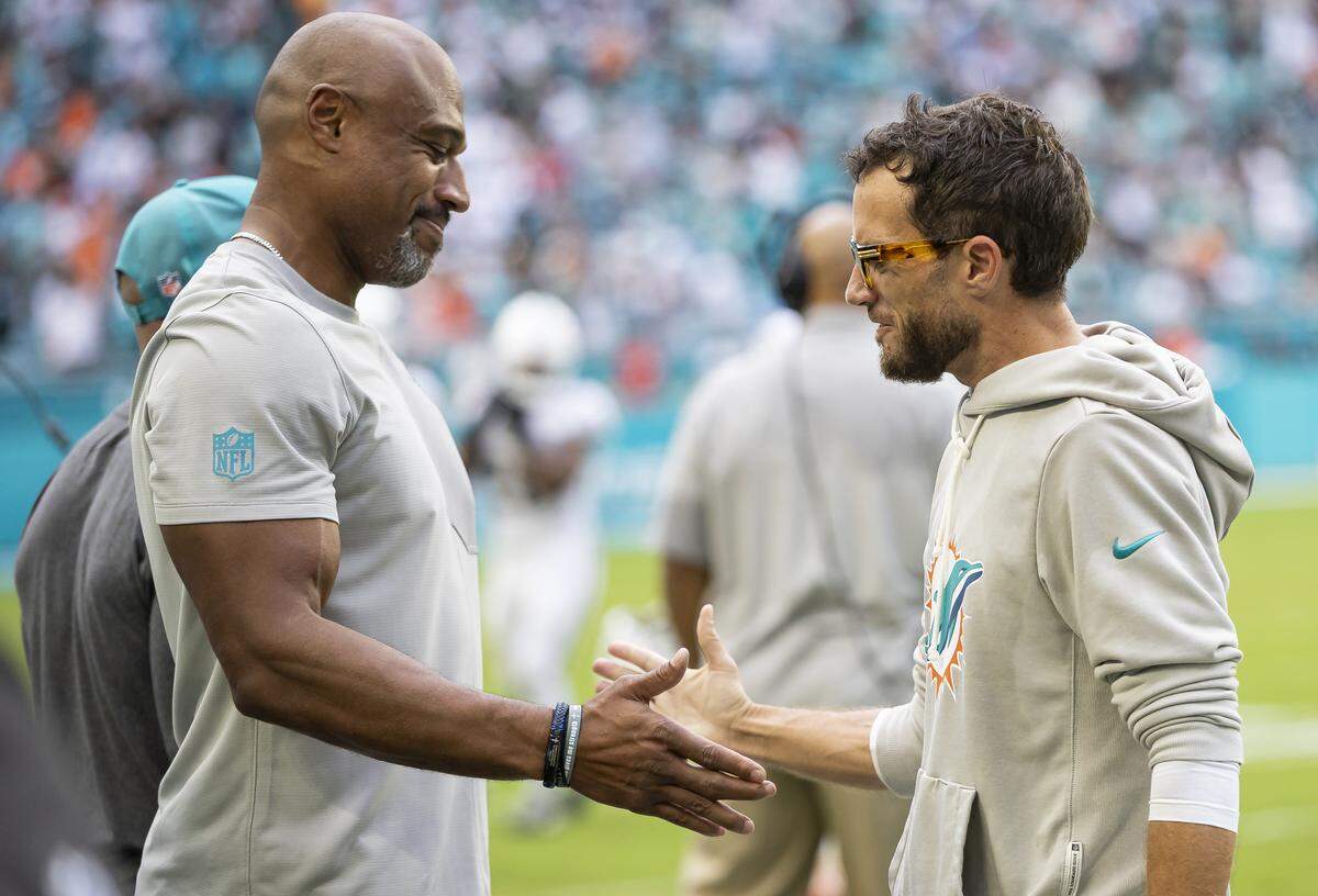 Miami Dolphins head coach Mike McDaniel and defensive coordinator Anthony Weaver celebrate after defeating the New Orleans Saints in their NFL game at Hard Rock Stadium on Sunday, Nov. 30, 2025, in Miami Gardens, Fla.
