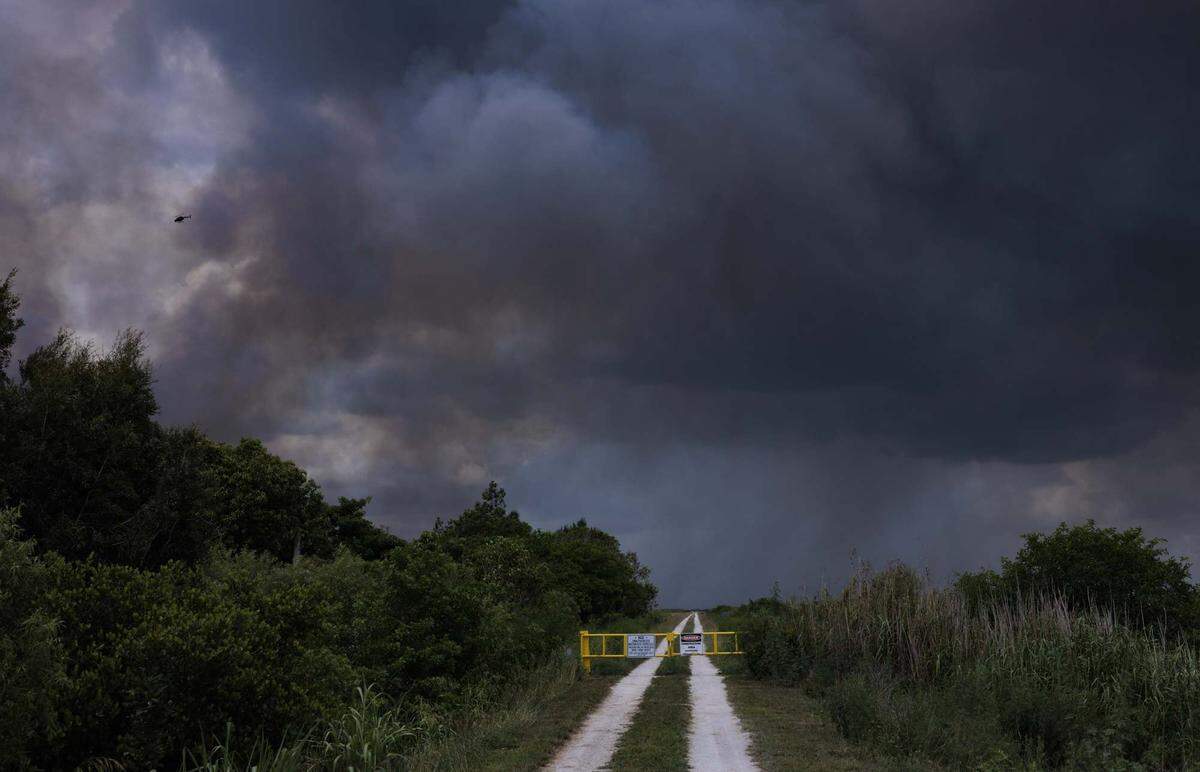 A wildfire burns west of Weston into the Everglades on Monday, May 11, 2026, seen from Everglades Holiday Park in Fort Lauderdale, Fla.