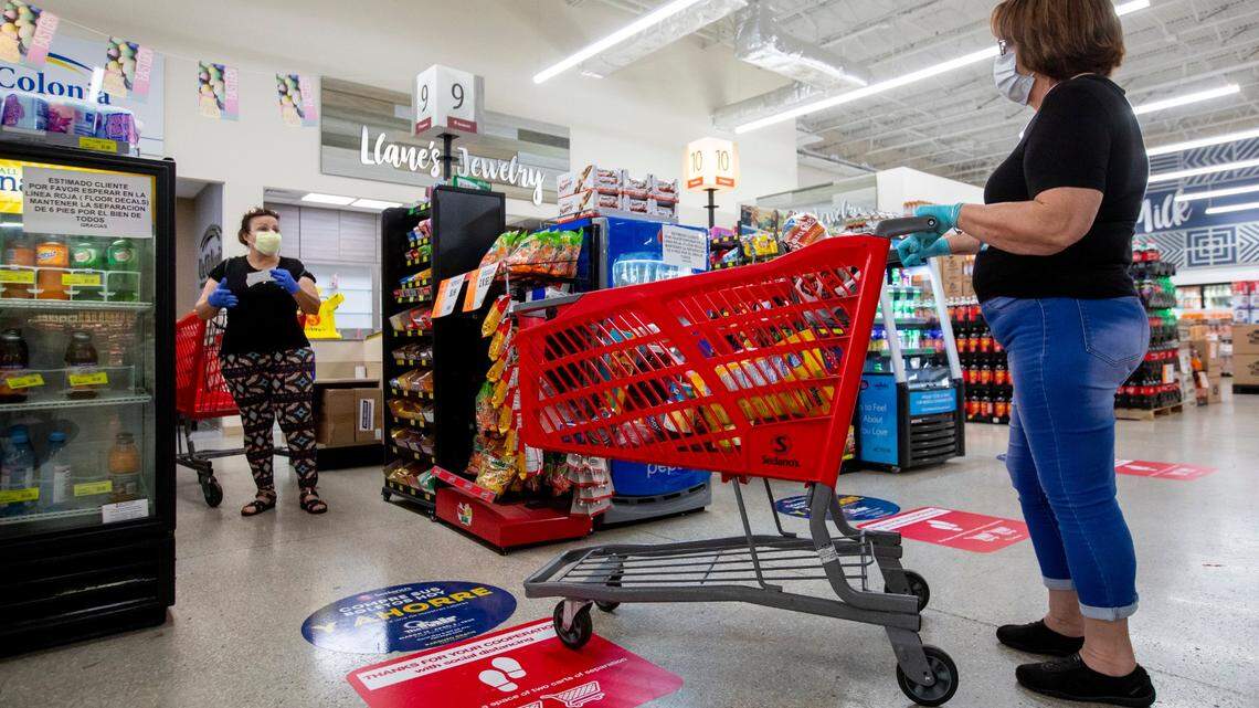 Shoppers line up to pay for their groceries at a Sedano’s Supermarket in Hialeah, Florida, on Wednesday, April 1, 2020.