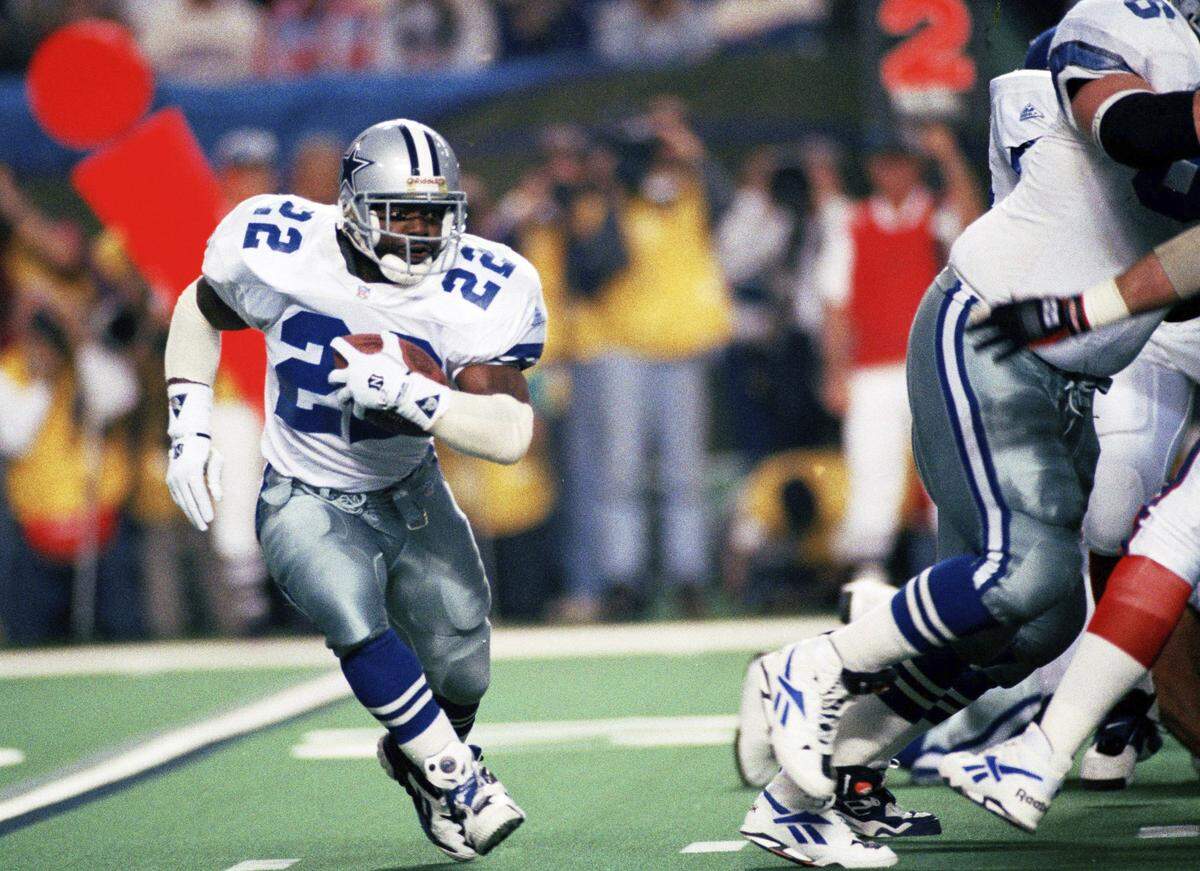 In this Jan. 30, 1994, file photo, Dallas Cowboys running back Emmitt Smith (22) runs for short yardage against the Buffalo Bills during Super Bowl XXVIII action at the Georgia Dome in Atlanta.