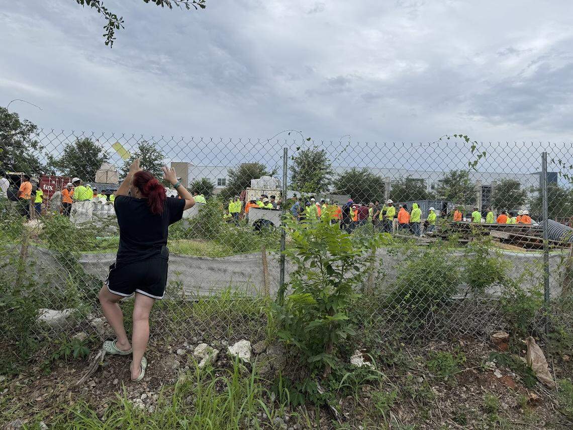 Amanda Parrish stands by a fence waiting for news about her husband, Faustino Macedo, who was detained during an immigration sweep led by U.S. Immigration and Customs Enforcement on May 29, 2025.