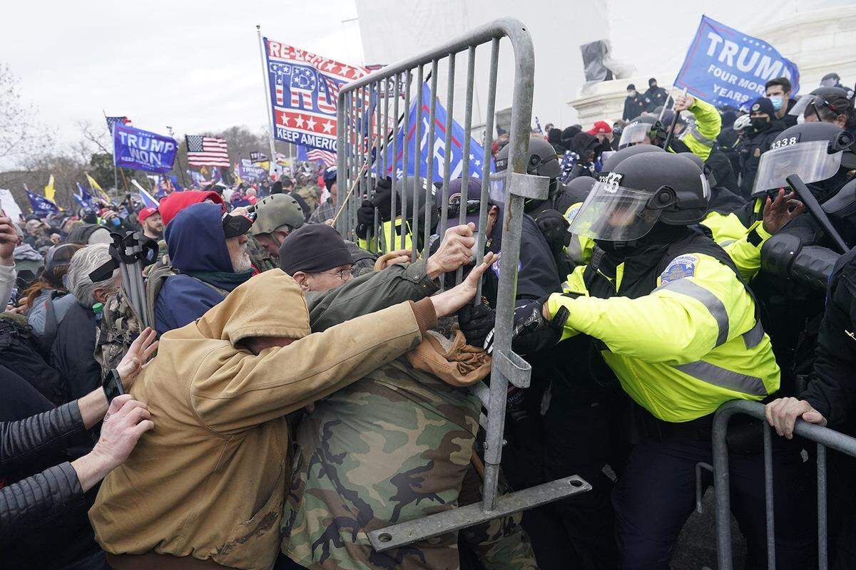 Supporters of President Donald Trump try to force their way through a police barricade in front of the U.S. Capitol on Jan. 6, 2021, hoping to stop Congress from finalizing Joe Biden’s victory in the 2020 presidential election.