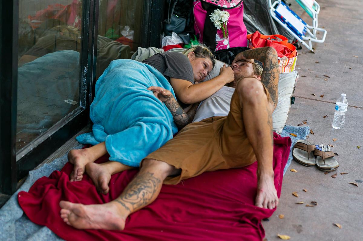 Ashley Bachman, 34, and her husband, Robert Bachman, 36, spend time near South Miami Avenue and Southwest 1st Street in downtown Miami as concerns over COVID-19 continue to spread through South Florida on Tuesday, April 14, 2020.