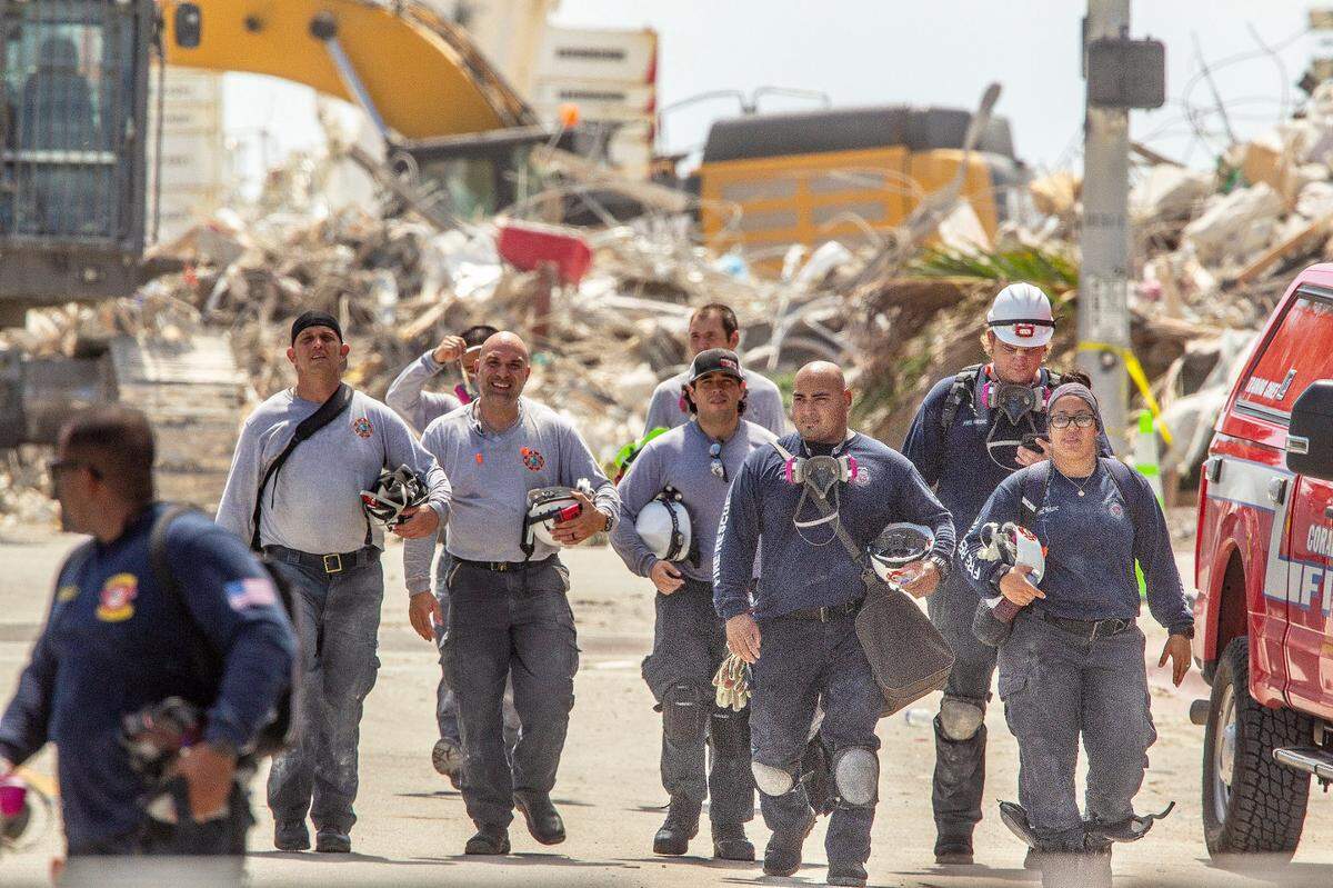 Rescue crew during a shift change, one day after the transition from search-and-rescue to recovery at Champlain Towers South condo collapse site in Surfside, on July 8.