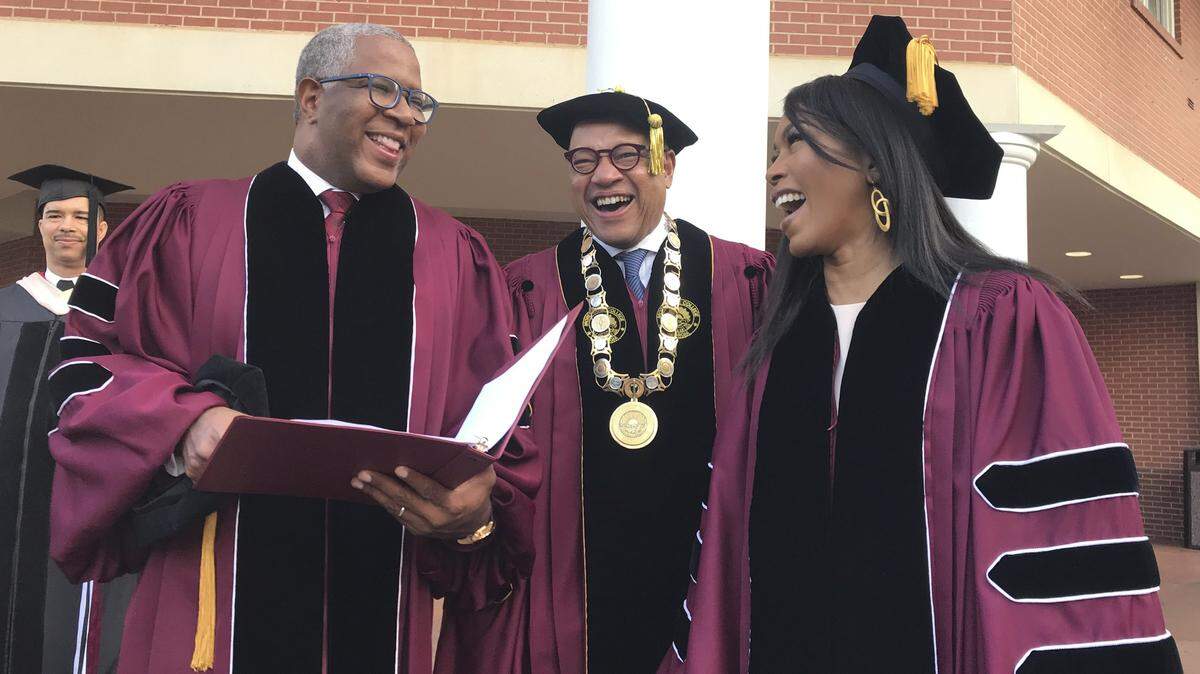 Robert F. Smith, left, laughs with David Thomas, center, and actress Angela Bassett at Morehouse College on Sunday, May 19, 2019, in Atlanta. Smith, a billionaire technology investor and philanthropist, said he will provide grants to wipe out the student debt of the entire graduating class at Morehouse College — an estimated $40 million.