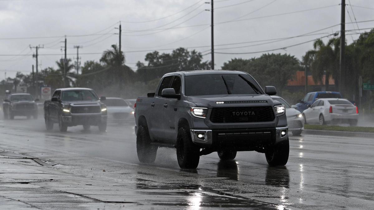Cars drive in the rain as stormy weather passes through Lighthouse Point on Friday, May 20, 2022.