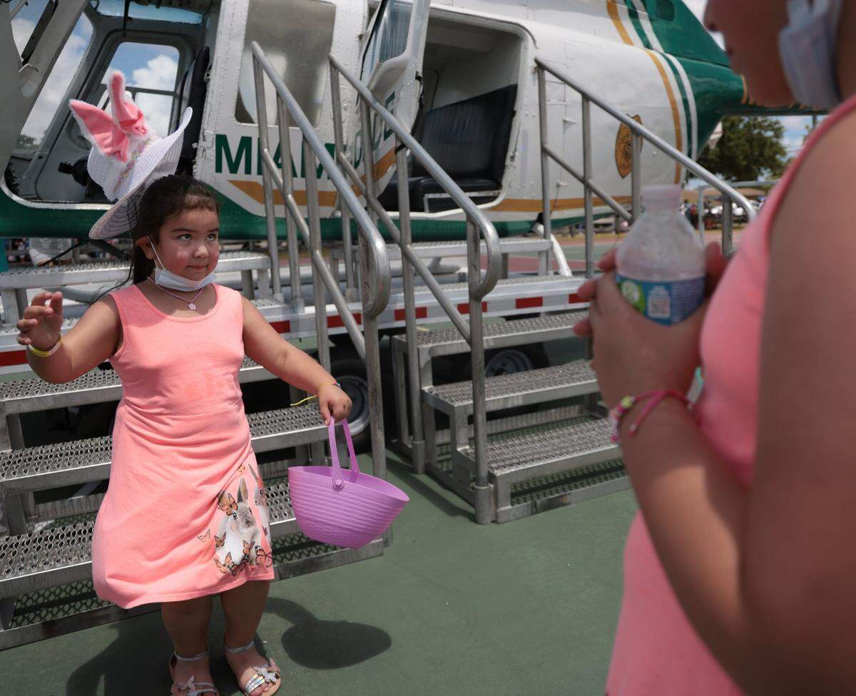 Miami Gardens resident Kayla, 6, bunny hops off the metal stairs after being photographed with her sister at the Miami Gardens Easter Day Eggstravaganza on Sunday, April 17.